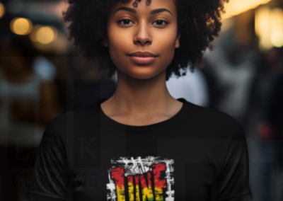 African American Woman with black curly hair wearing a black shirt with Juneteenth image
