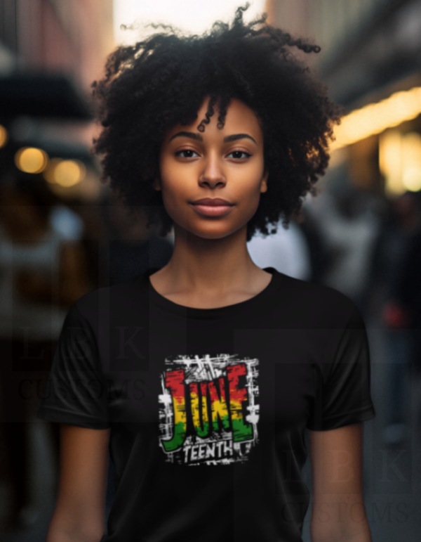 African American Woman with black curly hair wearing a black shirt with Juneteenth image