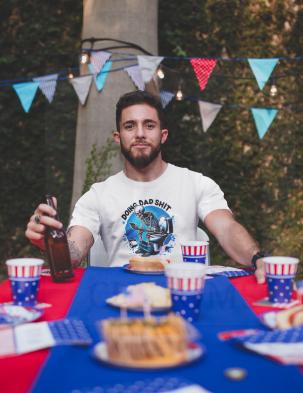 Man sitting at picnic table holding a beverage