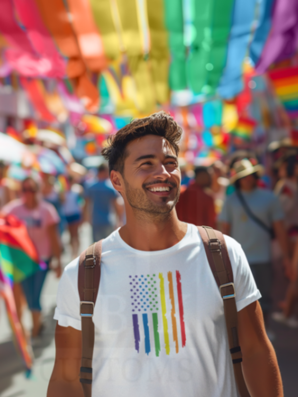 person smiling with white tee with pride color flag design on shirt.